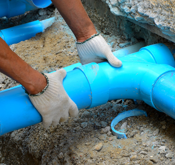 man installing new plumbing line